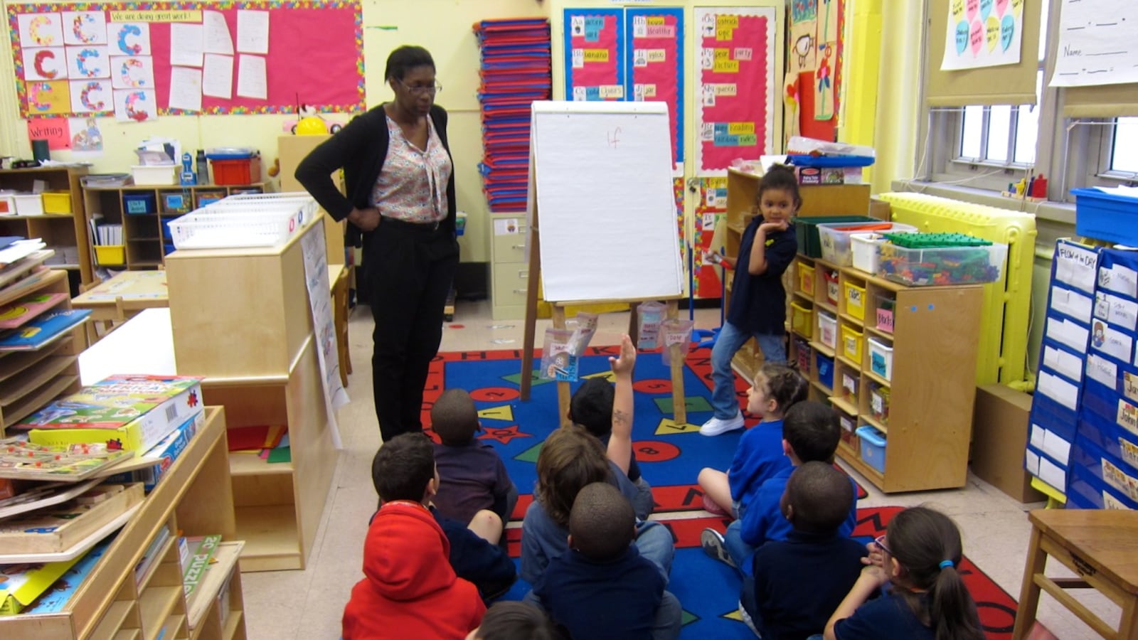 Judith Colon, left, asks her pre-K students at P.S. 63 to use the word "if" in a sentence.