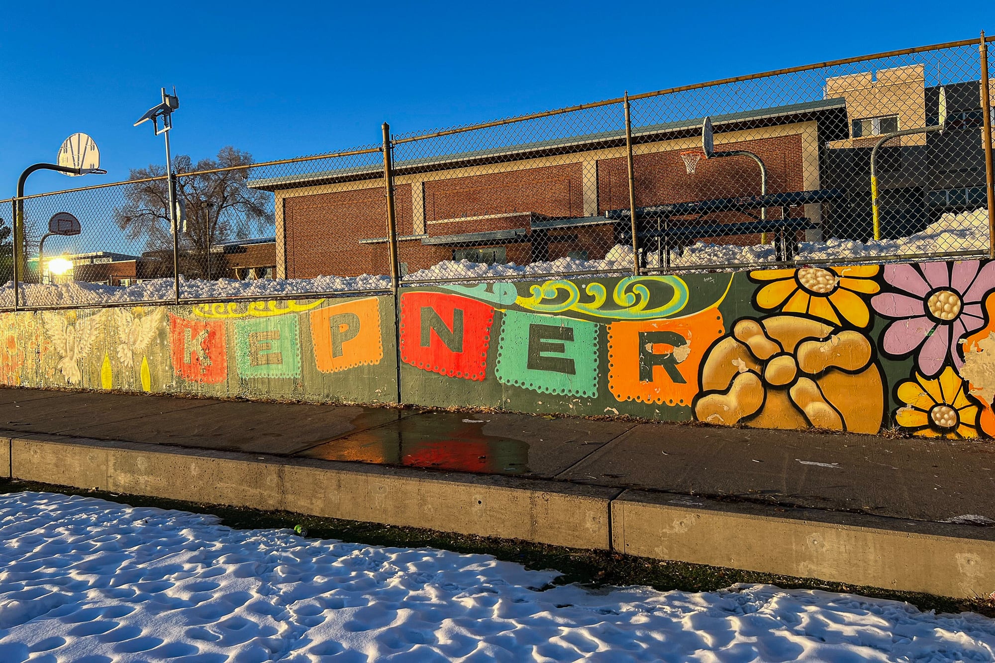 A colorful mural spelling “KEPNER” on a wall of a middle school campus