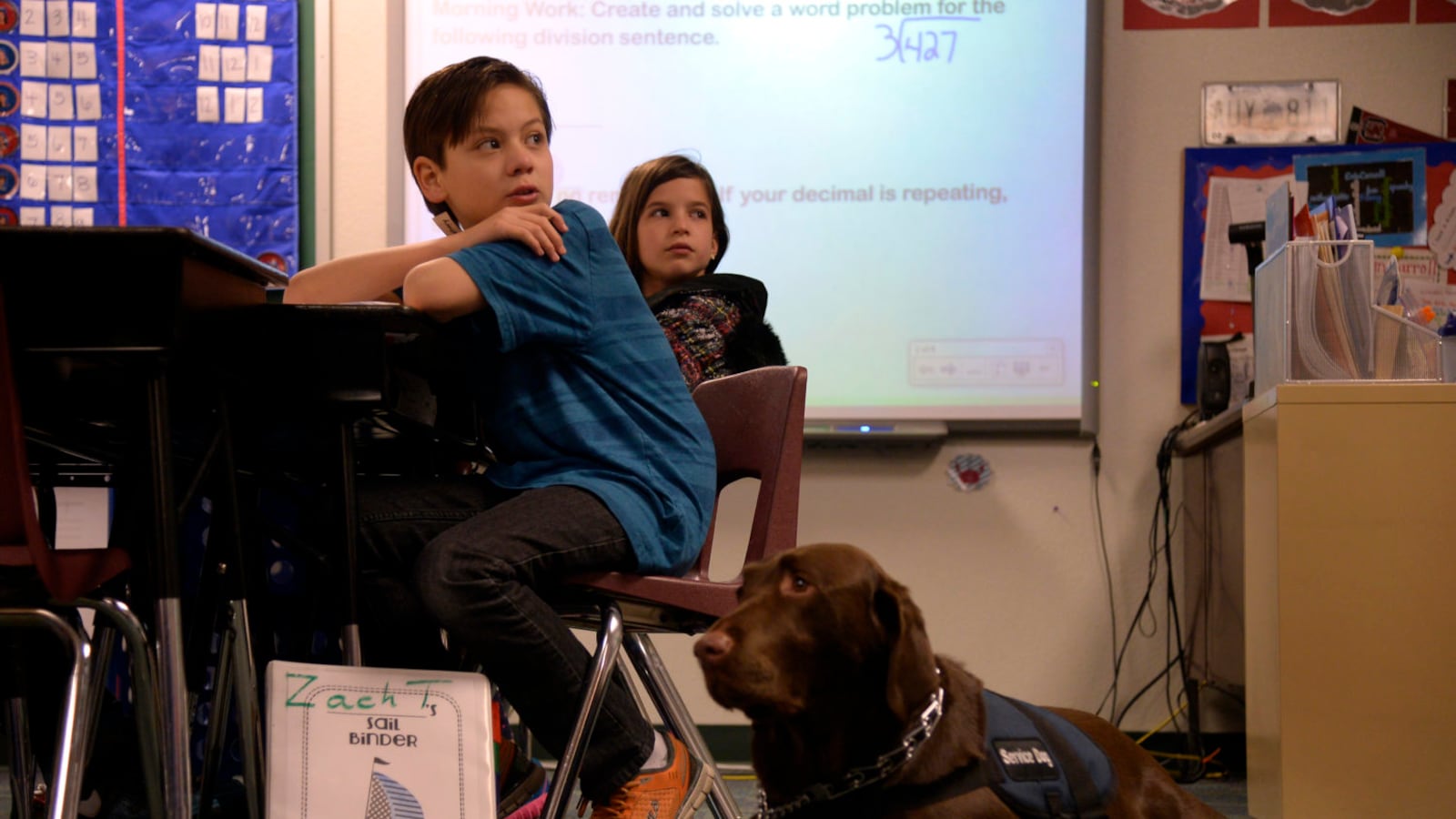 Zachary Tucker, a 5th grader in Colorado Springs, answers questions in class with his service dog, Clyde, in 2014. Clyde helps Zach with his Aspergers syndrome, a high functioning form of autism. (Photo By Joe Amon/The Denver Post via Getty Images)