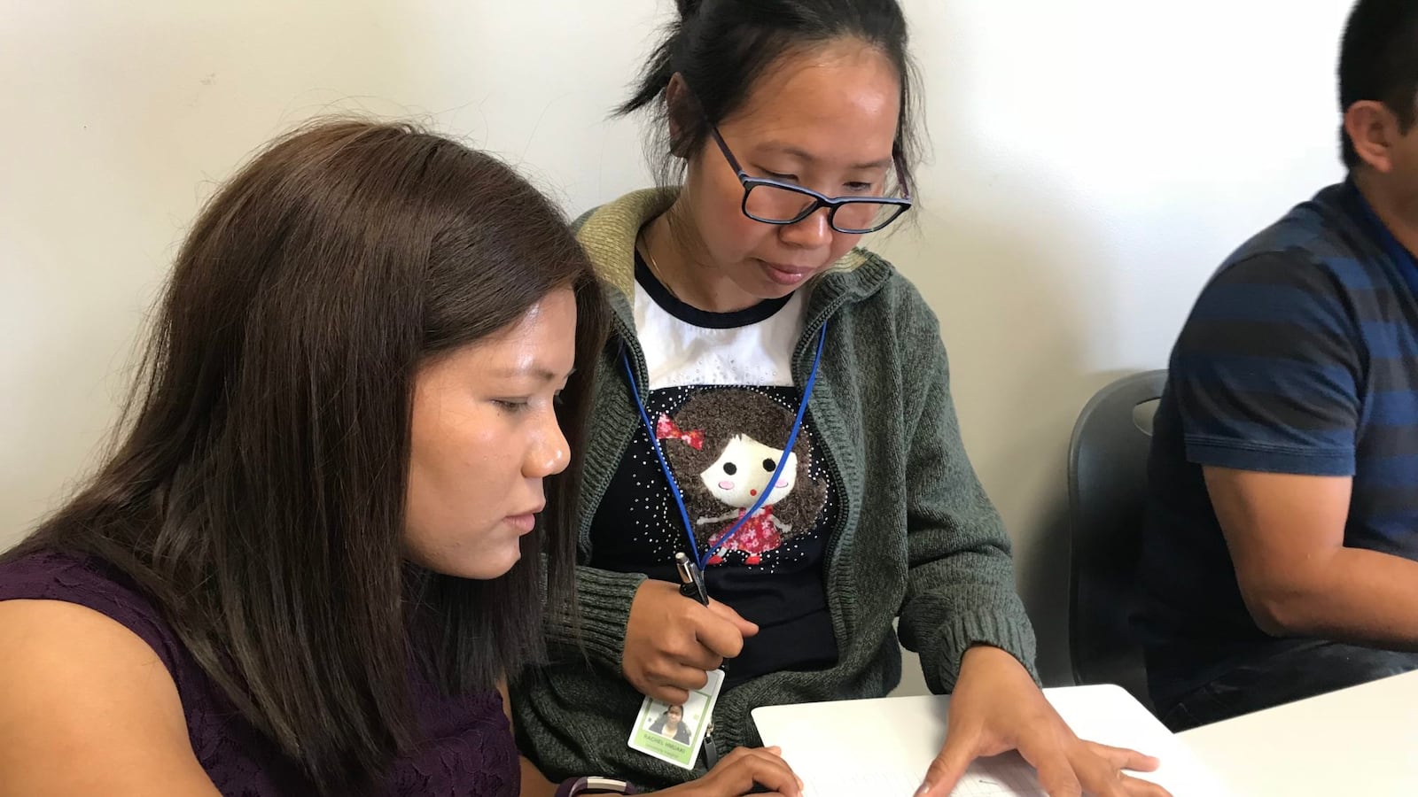 Pency Engmawii revises Rachel Hmuaki's paragraph during an English 2 class Wednesday. Engmawii left her Burmese village in Myanmar to pursue an education in the United States.