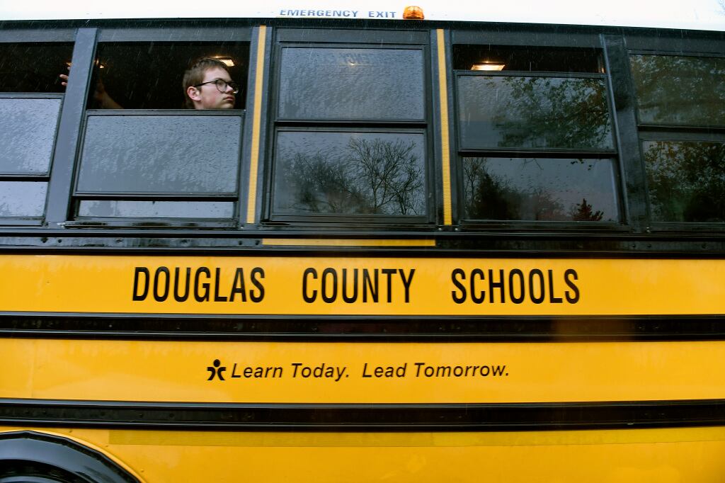 One students looks out the window of a Douglas County school bus.