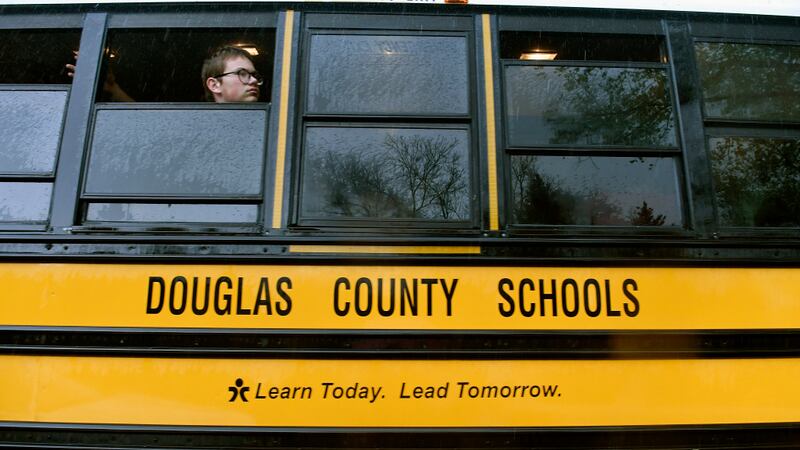 One students looks out the window of a Douglas County school bus.