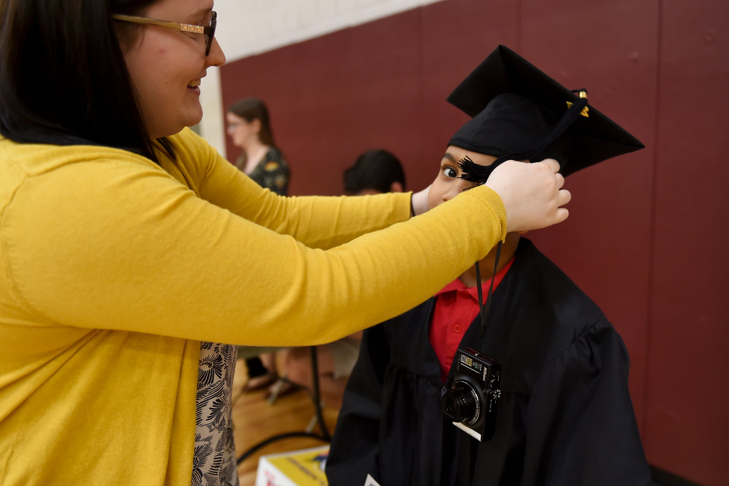 An adult woman wearing a yellow sweater