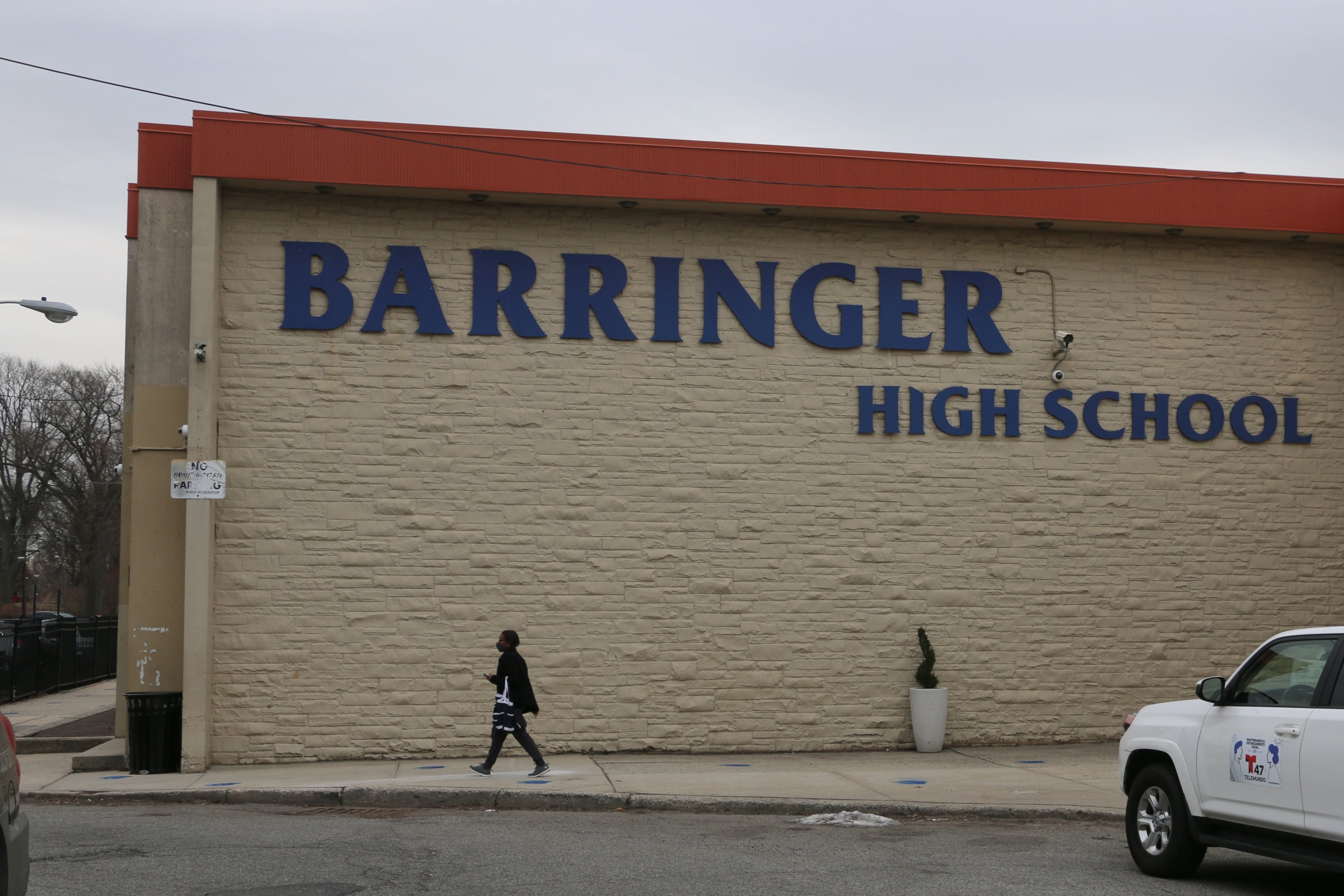 A person walks past the outside of Barringer High School on March 15, 2021.