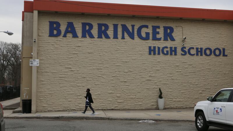 A person walks past the outside of Barringer High School on March 15, 2021.