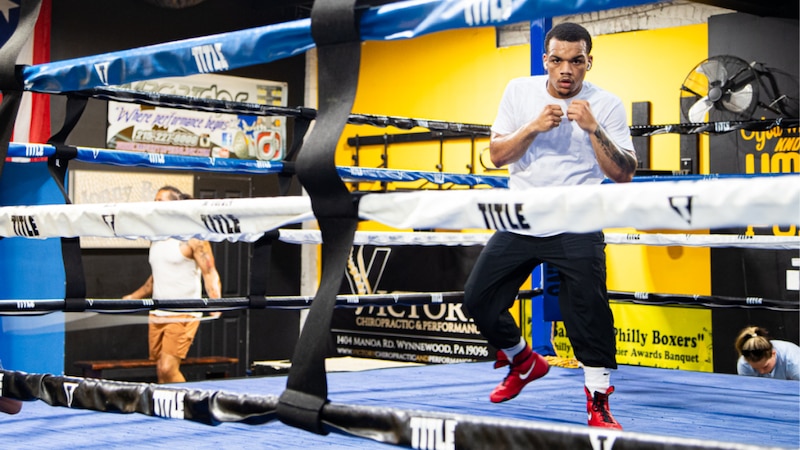 A photograph of a man in a boxing ring.