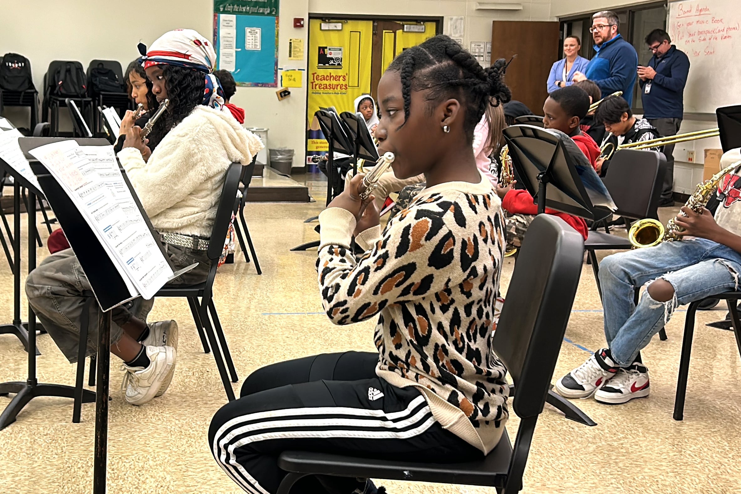 A female student in a leopard print shirt practices her music.