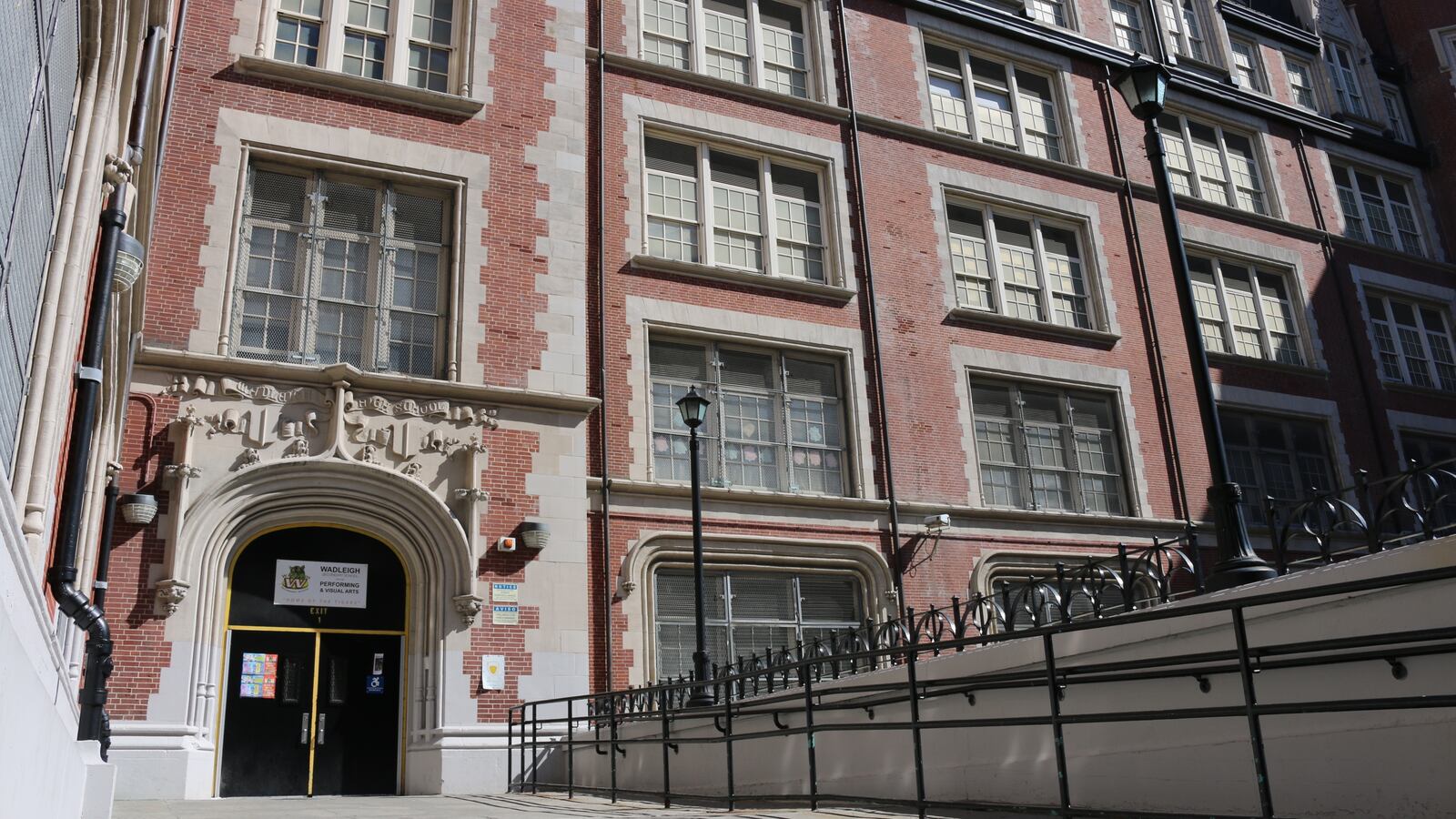 A brick gothic style school building on a sunny day in New York City