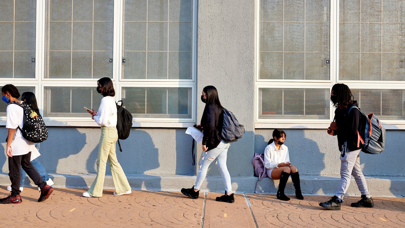 Students wait in line on school campus.