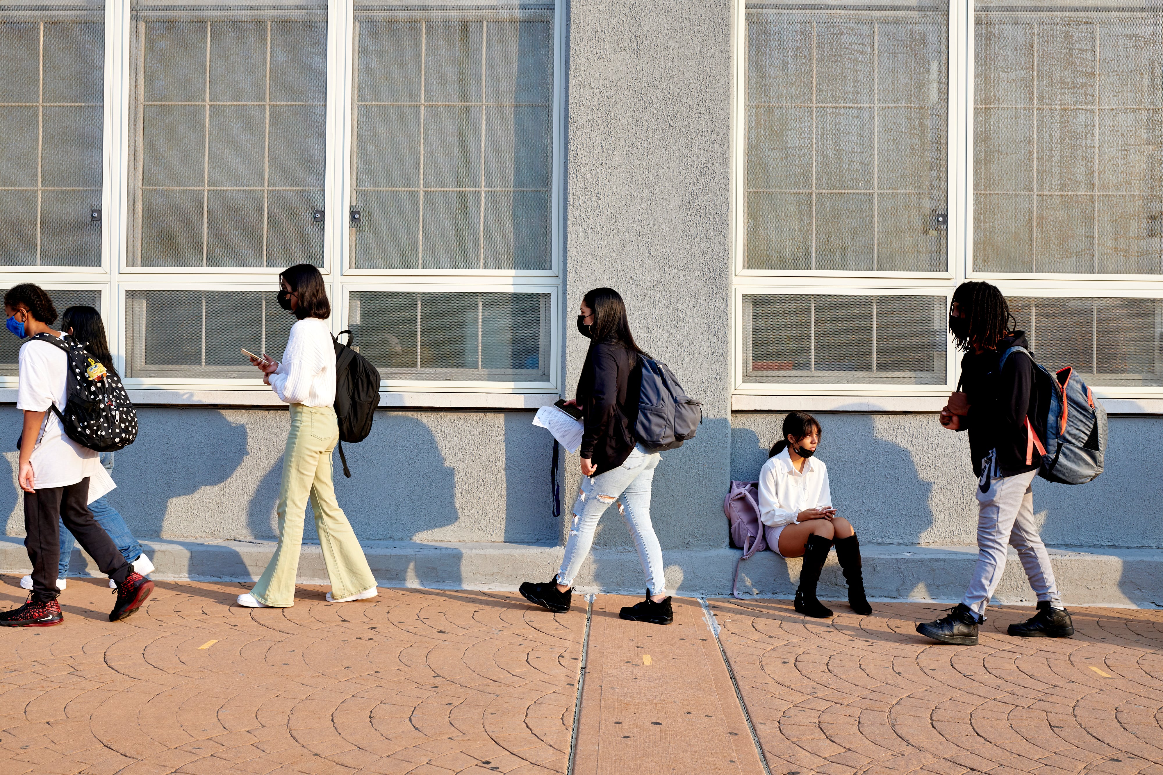 Students wait in line on school campus.