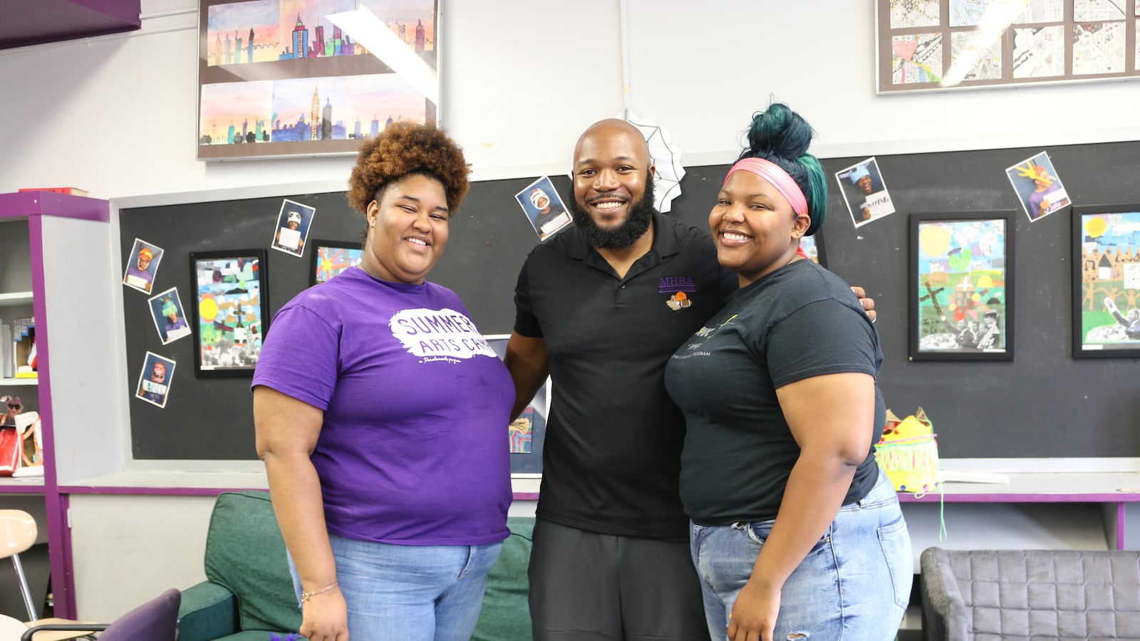 The Mott Hall Bridges Academy guidance counselor, Wesley McLeod, center, with two former students, whom he helped counsel after the deaths of their parents. The Brownsville middle school has been praised for its "grief-sensitive" approach to education.