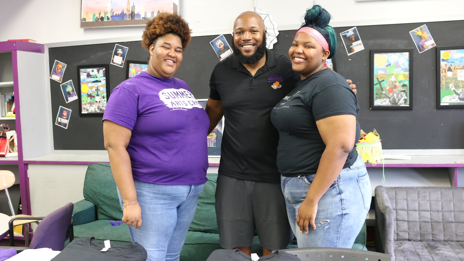 The Mott Hall Bridges Academy guidance counselor, Wesley McLeod, center, with two former students, whom he helped counsel after the deaths of their parents. The Brownsville middle school has been praised for its "grief-sensitive" approach to education.