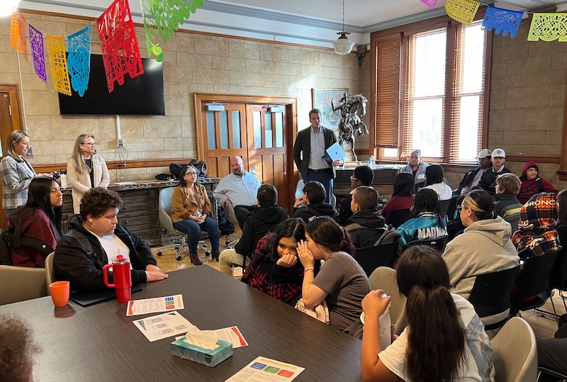A room full of people sitting in chairs.