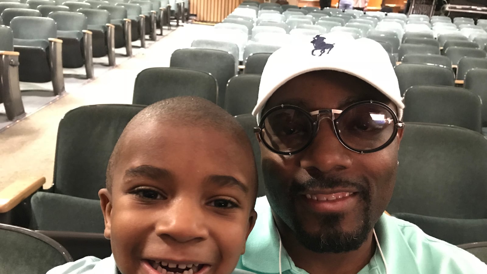 Dwayne Walker sits with son, Braylen, during a break at Dad's Day in Pre-K