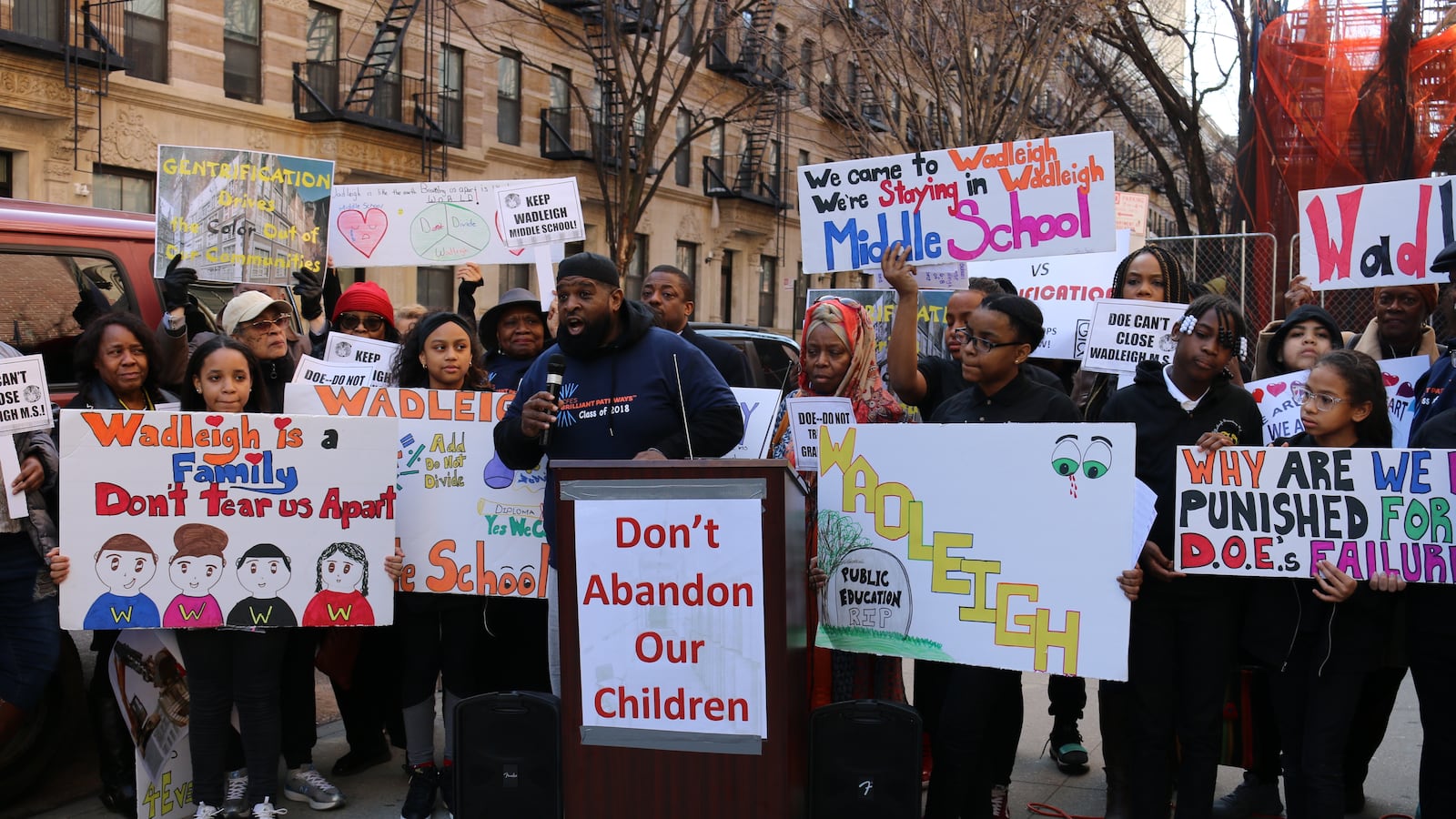 A Wadleigh graduate addresses the crowd at a rally outside the school. Students, parents and community leaders spoke against the city's plans to close the Harlem performing arts school.