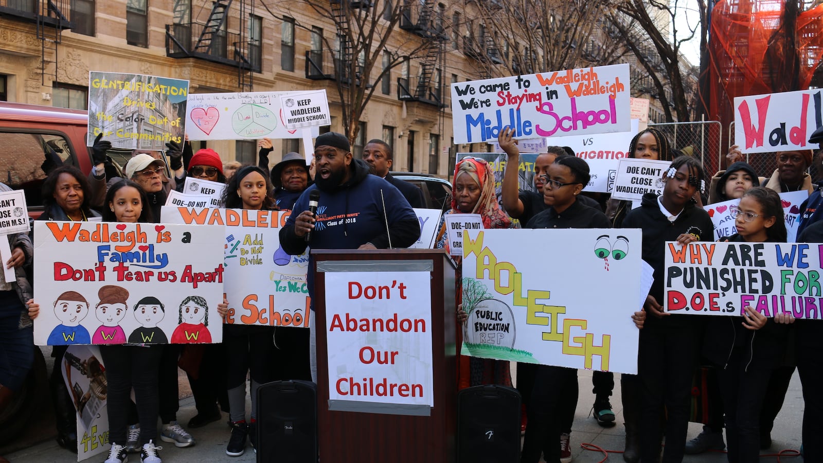 A Wadleigh graduate addresses the crowd at a rally outside the school. Students, parents and community leaders spoke against the city's plans to close the Harlem performing arts school.