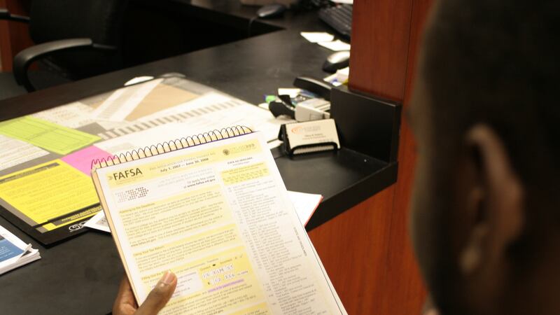 Student looking at a FAFSA information sheet