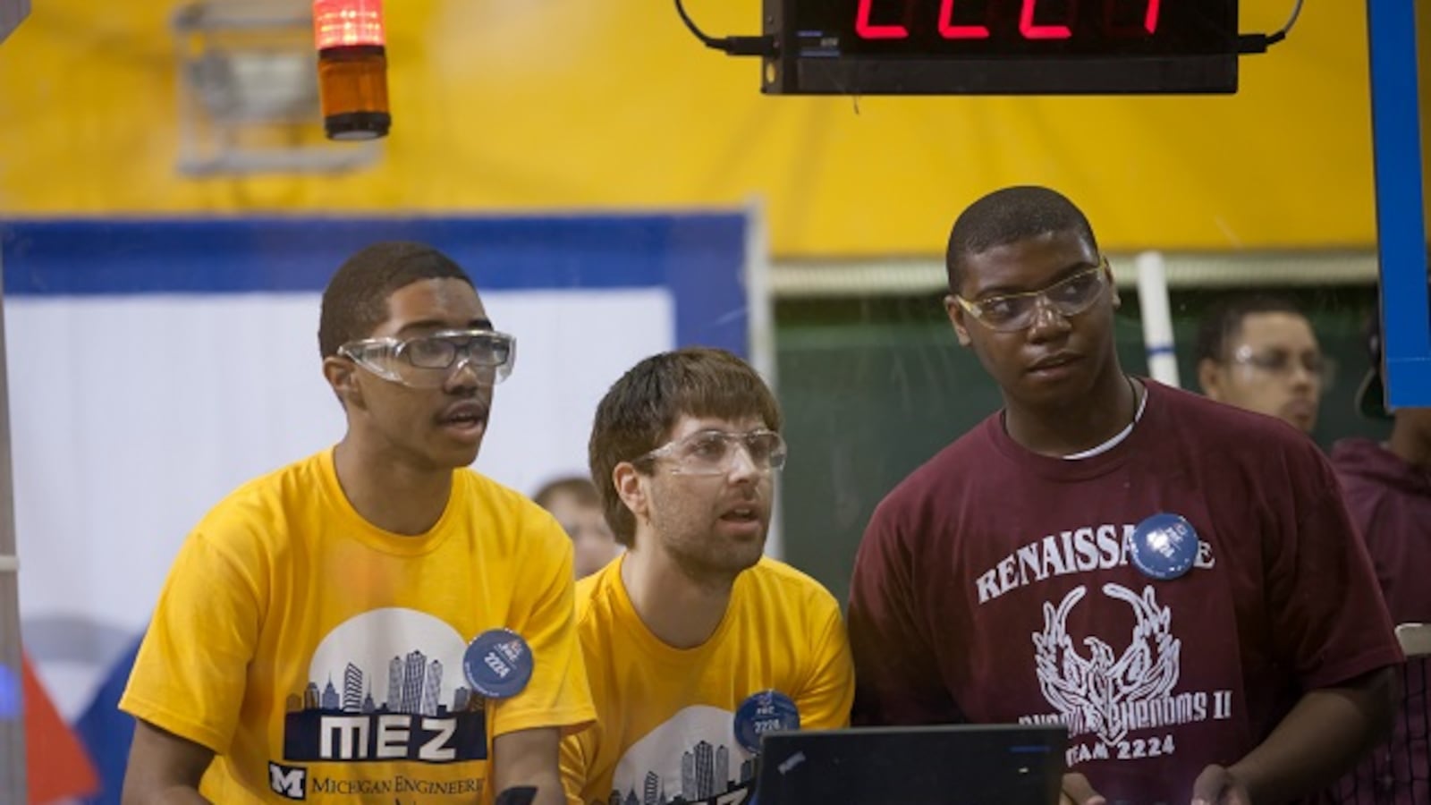 A student wearing a Renaissance High School t-shirt competes in a robotics competition.