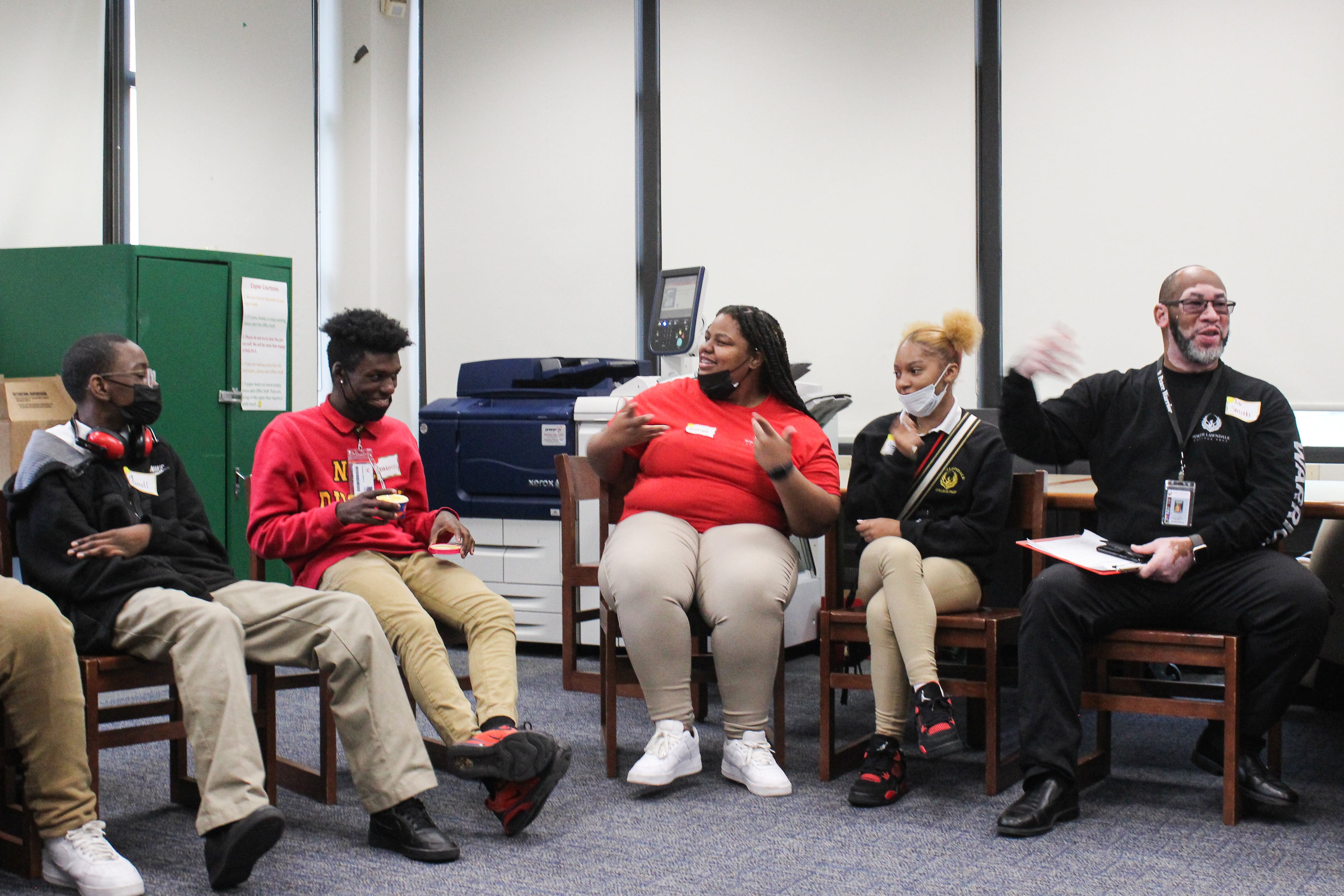 Peace Warriors and their advisor Gerald Smith sit in a circle during a training in mid-October alongside students aspiring students at North Lawndale College Prep.