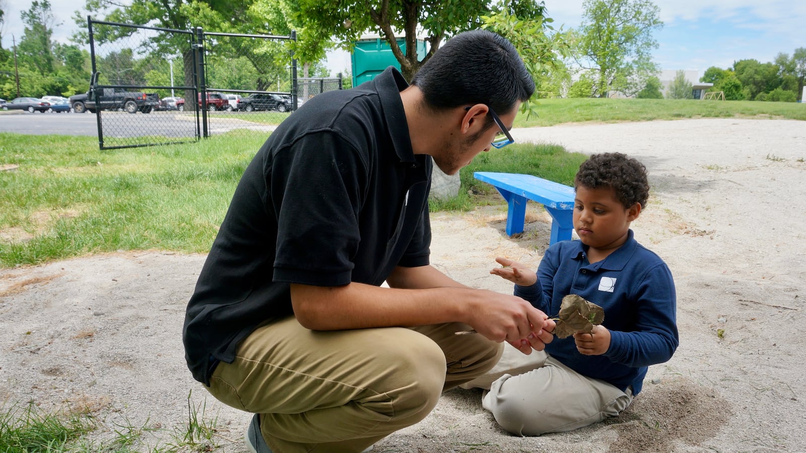 A high school student at Christel House Academy South works outside with another student.
