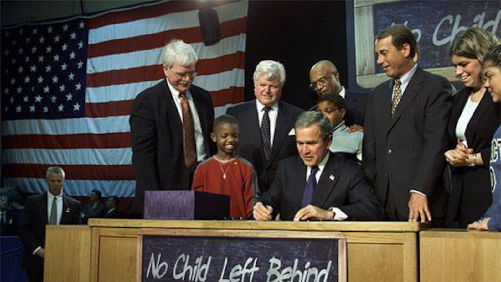 President George W. Bush signs into law the No Child Left Behind Act on Jan. 8, 2002 at Hamilton High School in Hamilton, Ohio.