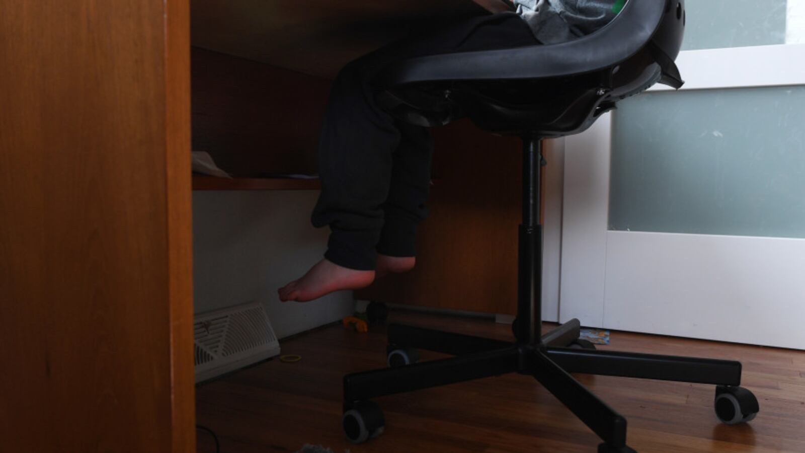 Seven-year-old Lenox Pineau, a second grader in Jeffco Public Schools, works on doing his first day of online learning in his room at his family’s home on March 17, 2020 in Lakewood, Colorado.