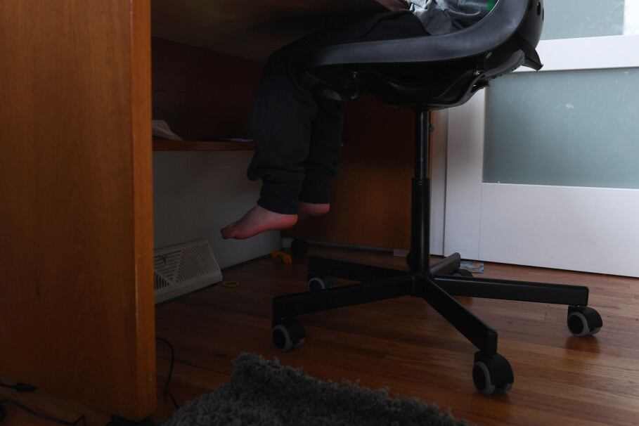 Seven-year-old Lenox Pineau, a second grader in Jeffco Public Schools, works on doing his first day of online learning in his room at his family’s home on March 17, 2020 in Lakewood, Colorado.
