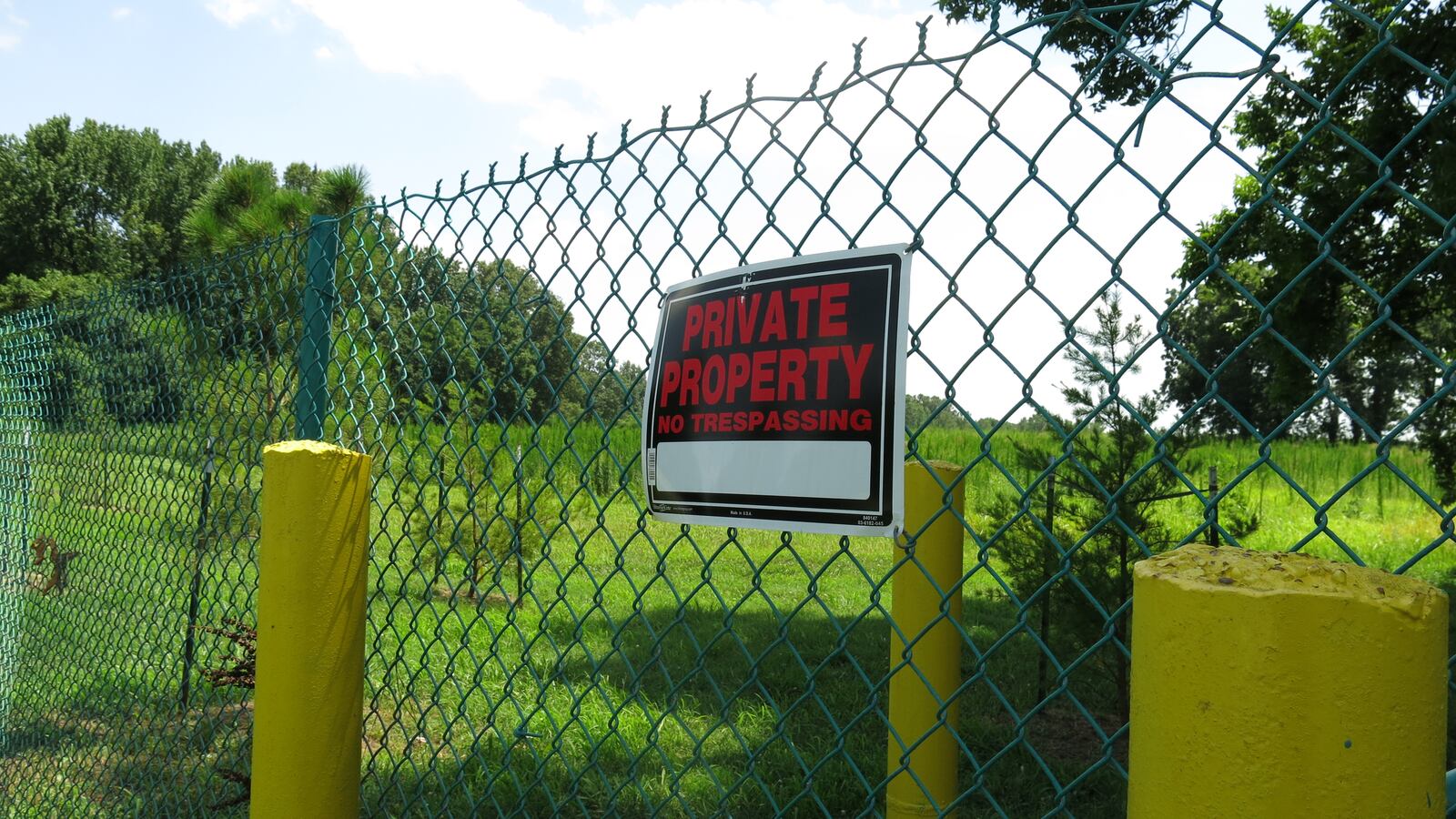 A sign hangs on a fence surrounding the property where a proposed landfill expansion would get even closer to a nearby Memphis elementary school.