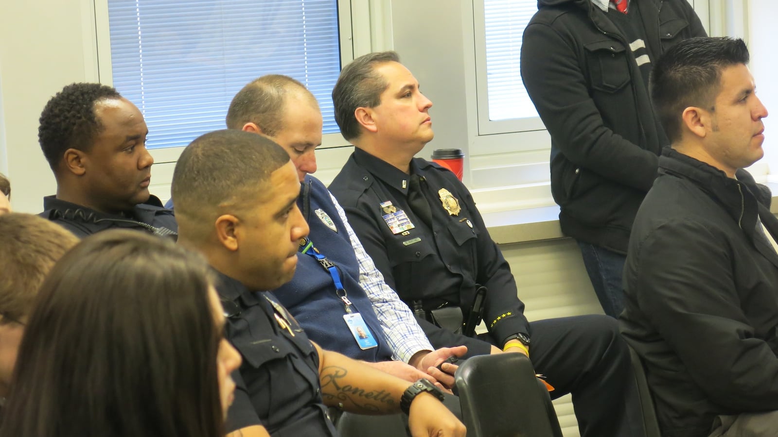 Members of the Denver Police Department watch as students from Manual High School share speeches about Ferguson.