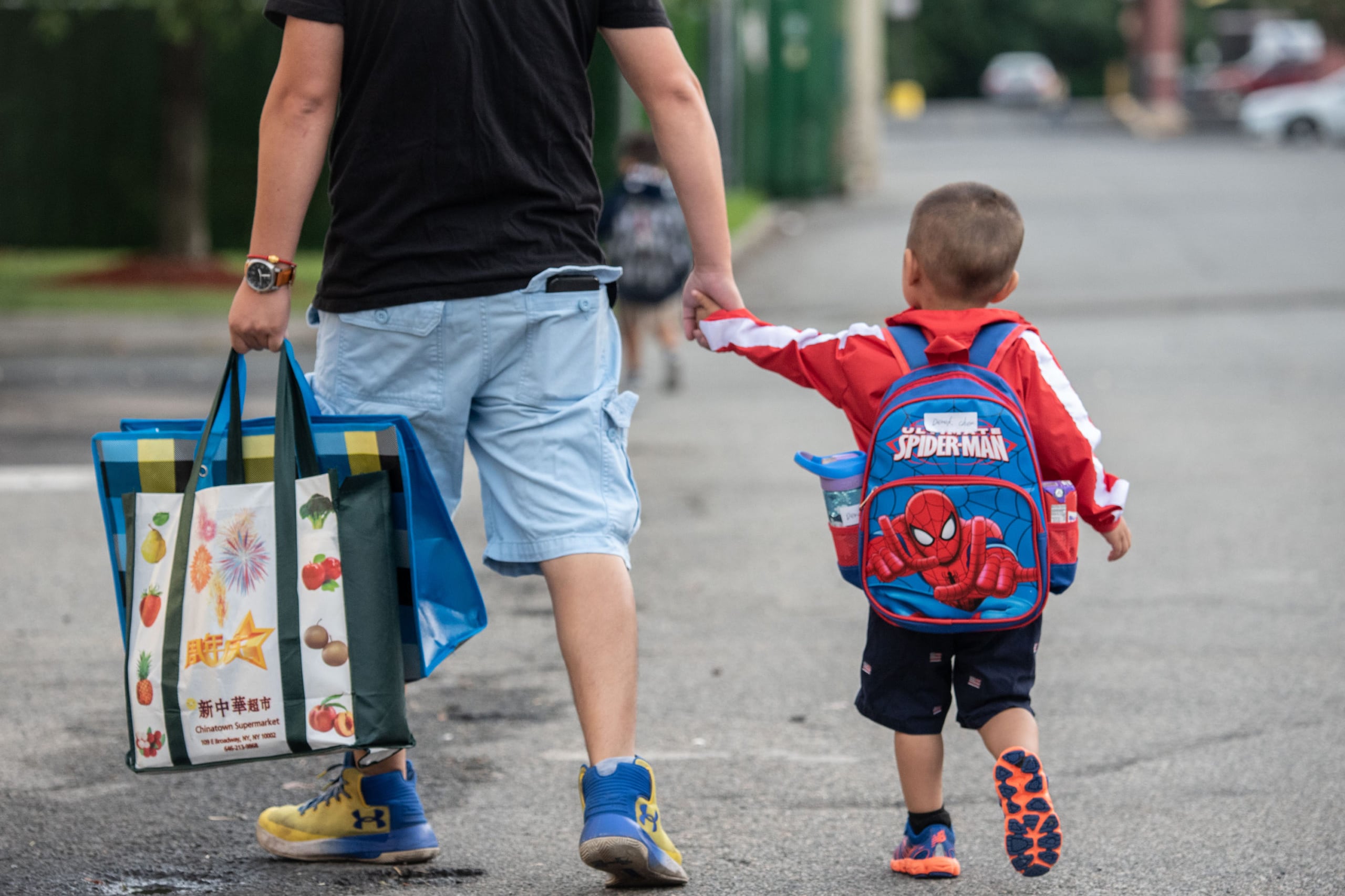 A father brings his child to a Staten Island Pre-K program during the first day of school in 2019. On Wednesday, Mayor Bill de Blasio announced that NYC would tap into federal pandemic relief funds to make preschool universal for 3-year-olds.
