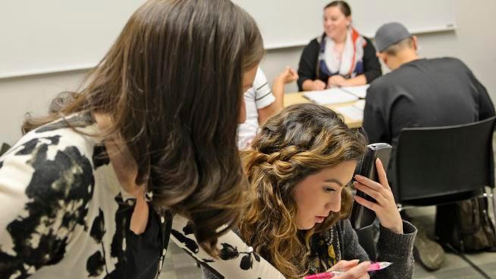 Math instructor Kellie Zolnikov, left, helps Kaitlin Carrasco, a student at Metro State University, during a math lab in 2014. Carrasco, 19, said she has always struggled in math, but scored high enough on her entrance exam to take the supplemental math lab she needs for a business management degree.