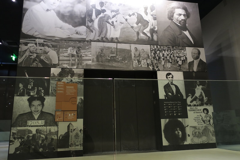 A display in of black and white photos in a display case of different African American activists including Rosa Parks and Angela Davis different scenes of life.