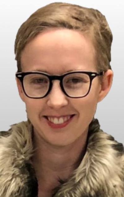 Headshot of a woman with short blond hair wearing glasses