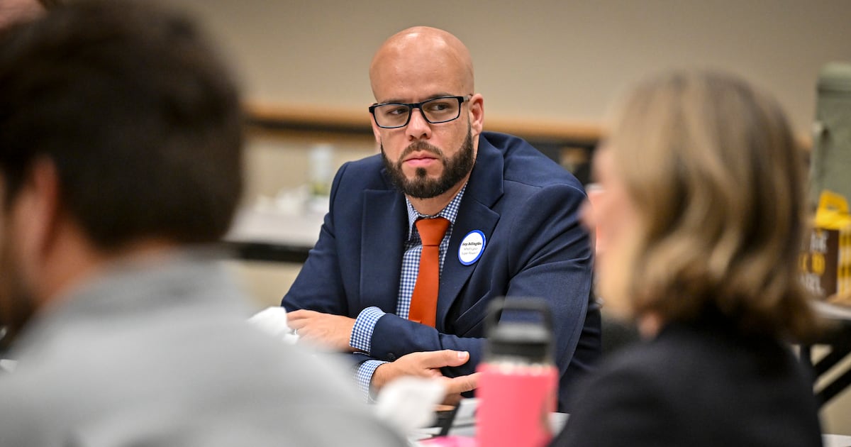 Denver Public Schools Superintendent Alex Marrero seated at a table listening to school board members during a meeting.