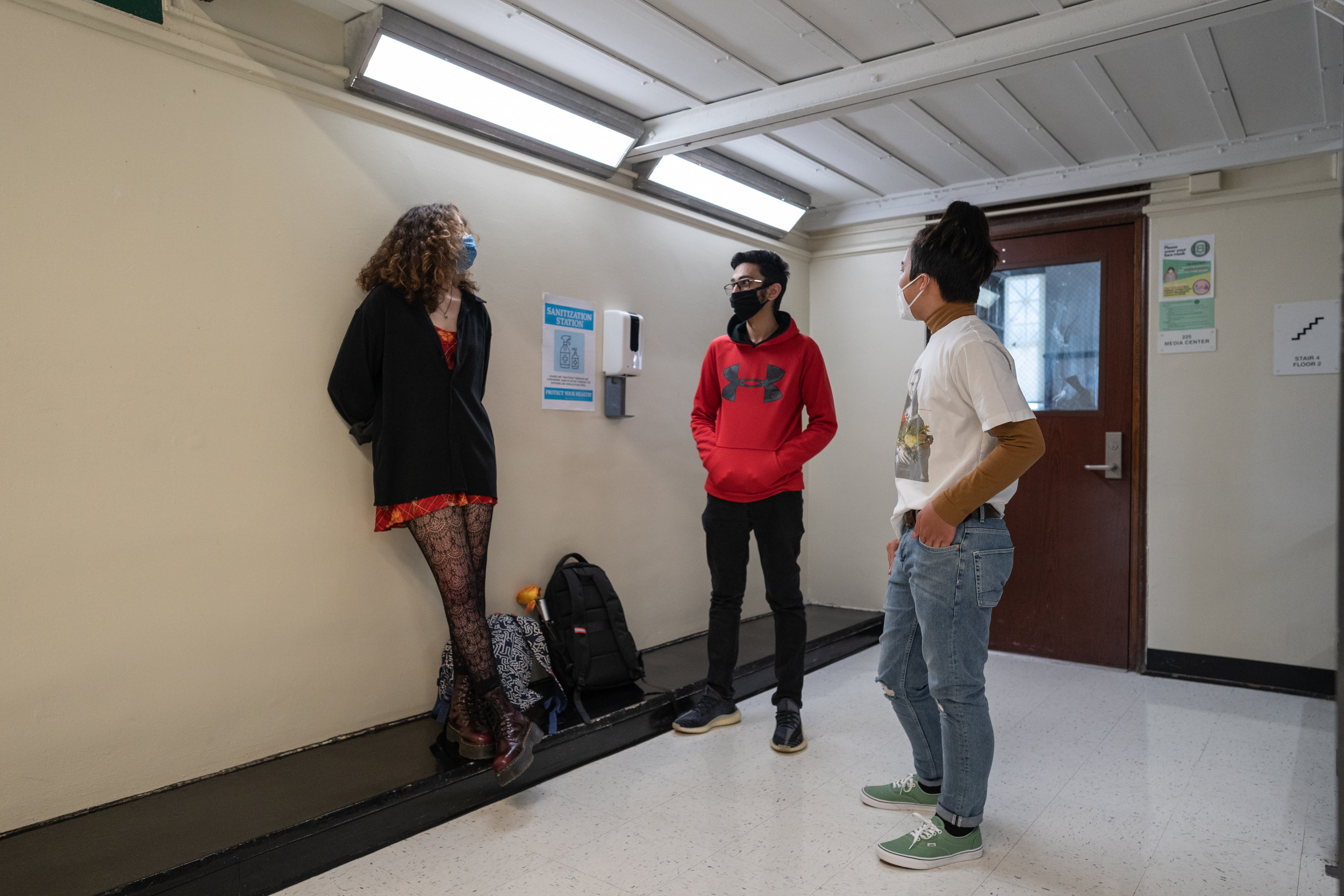 Students, including Muhammad Khan at center, chat in the hallway on the first week back to classrooms on April 23, 2021.