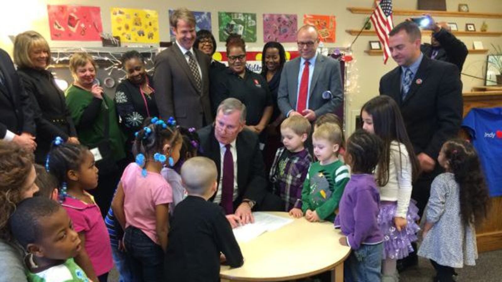 Mayor Greg Ballard signs the city's preschool ordinance in December at Warren Township Schools.