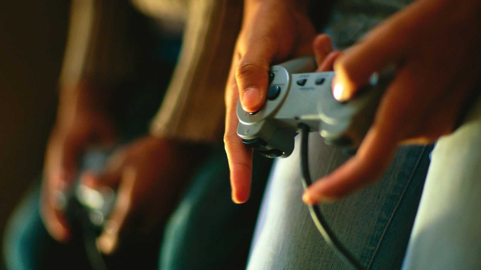 Hands of children playing a video game.