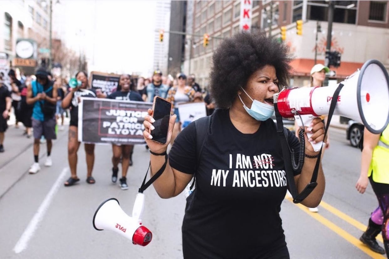 A person speaks through a megaphone during a protest.