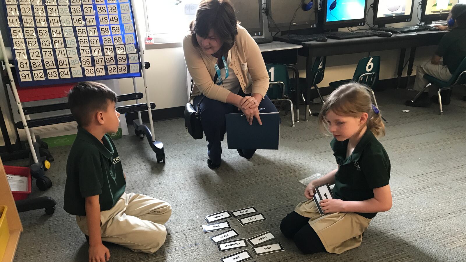 Amesse community review board member Michele Houtchens visits with students at STRIVE Prep Ruby Hill.