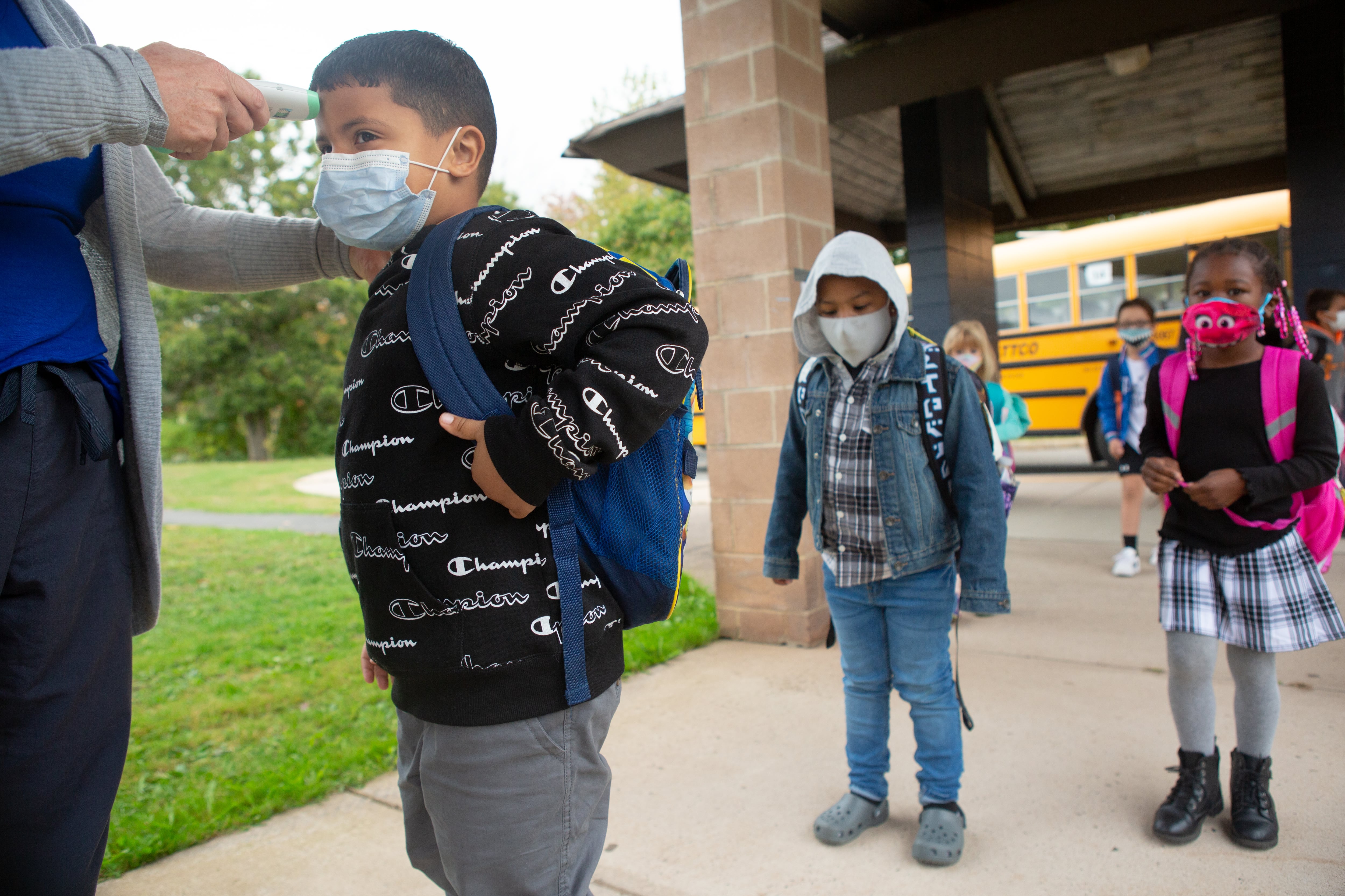 Students are giving temperature checks by the school nurse before being allowed into the building at Wesley Elementary School in Middletown, CT, October 5, 2020.