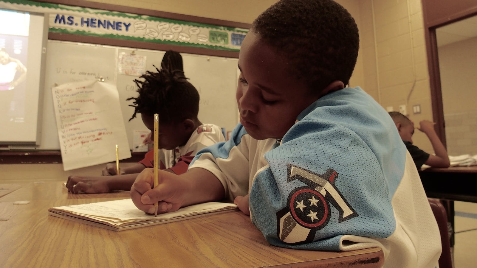 Third-grader Brieston Fleming, 8, writes a story about his favorite athlete, Dwayne Johnson, after reading several books about sports stars during the last week of the state-funded Read to be Ready literacy camp at Cornerstone Prep in Memphis' Frayser neighborhood. June 27, 2019.