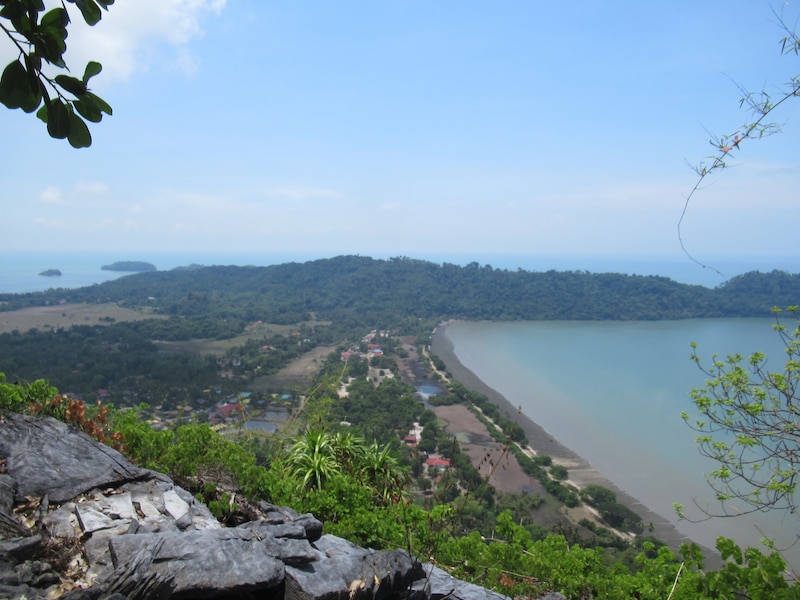Homes and lush greenery line the coast of Pulau Tuba, Malaysia