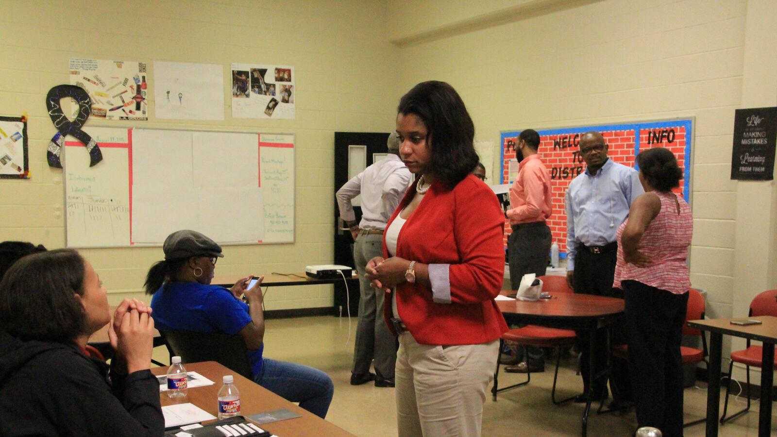 Leshundra Robinson, a Memphis organizer for The Campaign for School Equity, speaks with a parent in Memphis' Whitehaven community.