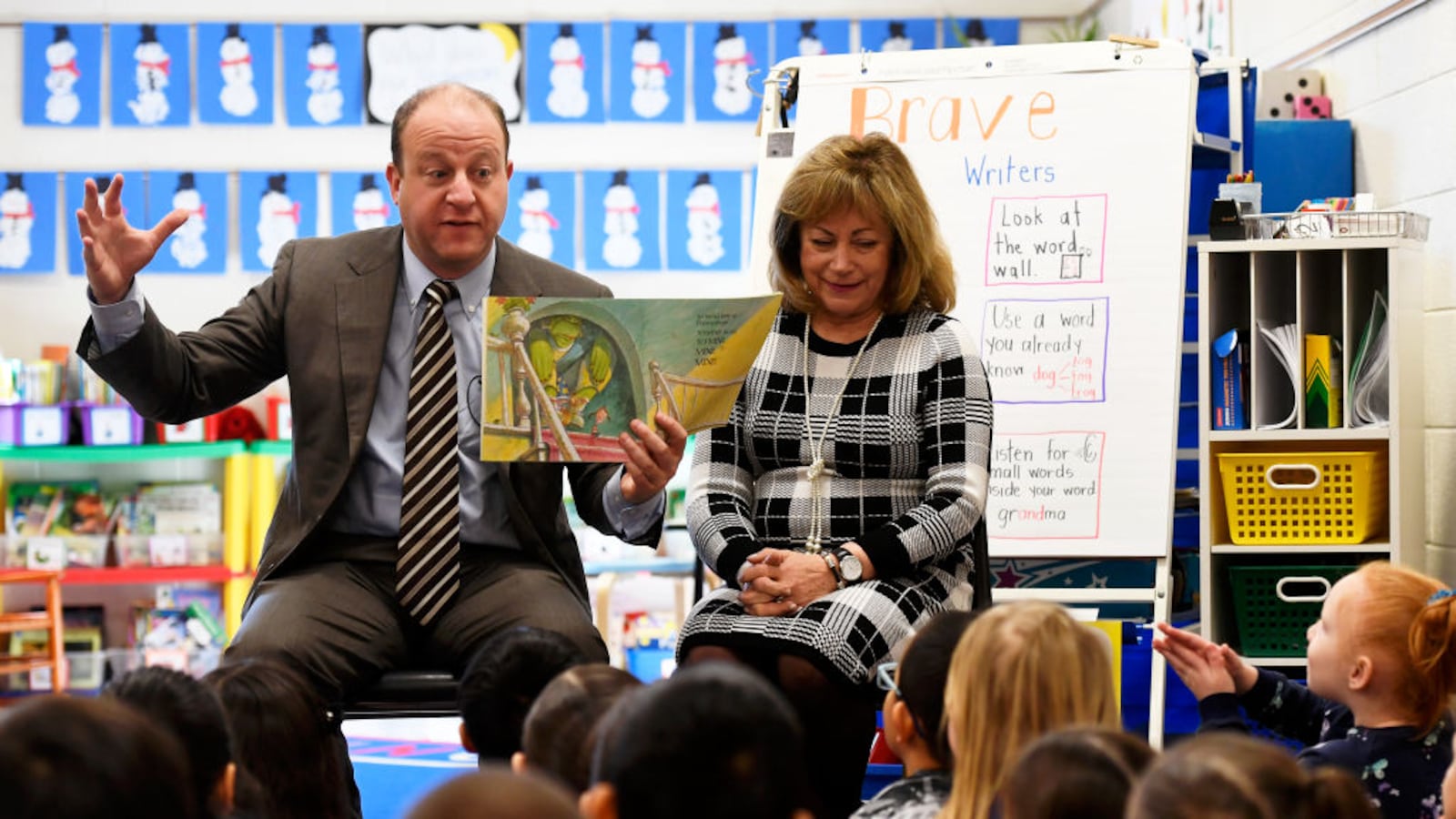 Colorado Governor Jared Polis with Lt. Gov. Dianne Primavera beside him reads "The Boy Who Wouldn't Share" to Jessica Lovato's kindergarten class at Denver's Centennial Elementary.
