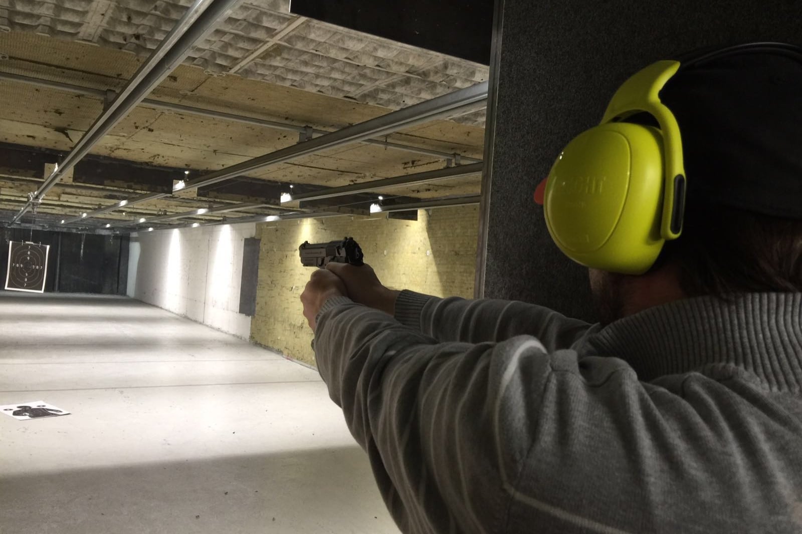 Closeup of man aiming a gun at a target