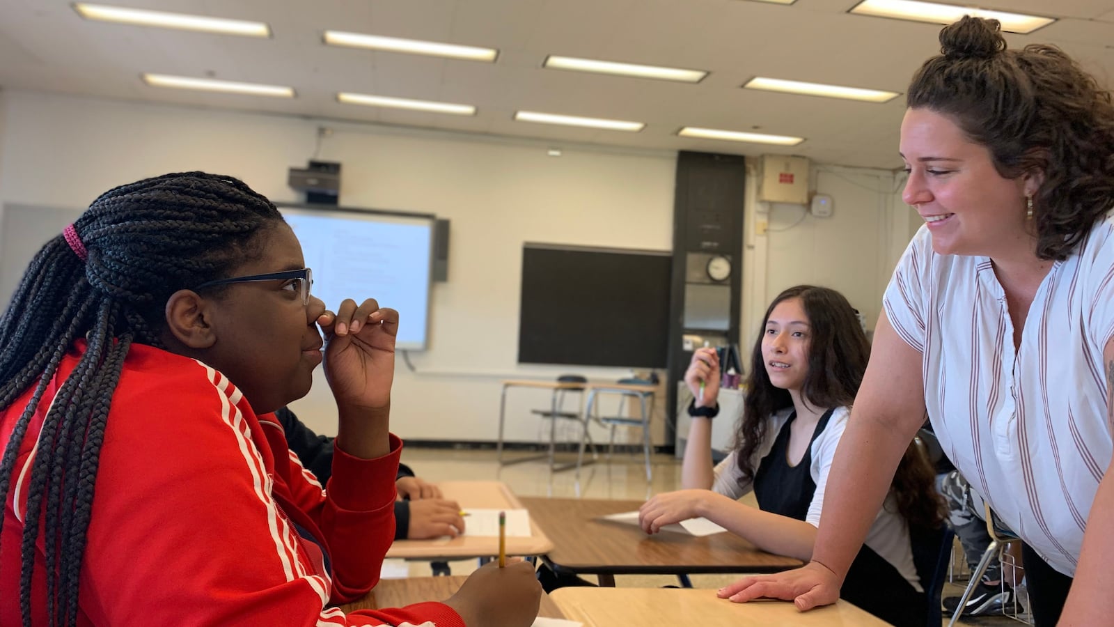 Chemistry teacher Shelby Redman checks in with a student named Jamaria during Freshman Connection at Roberto Clemente Community Academy in August 2019.