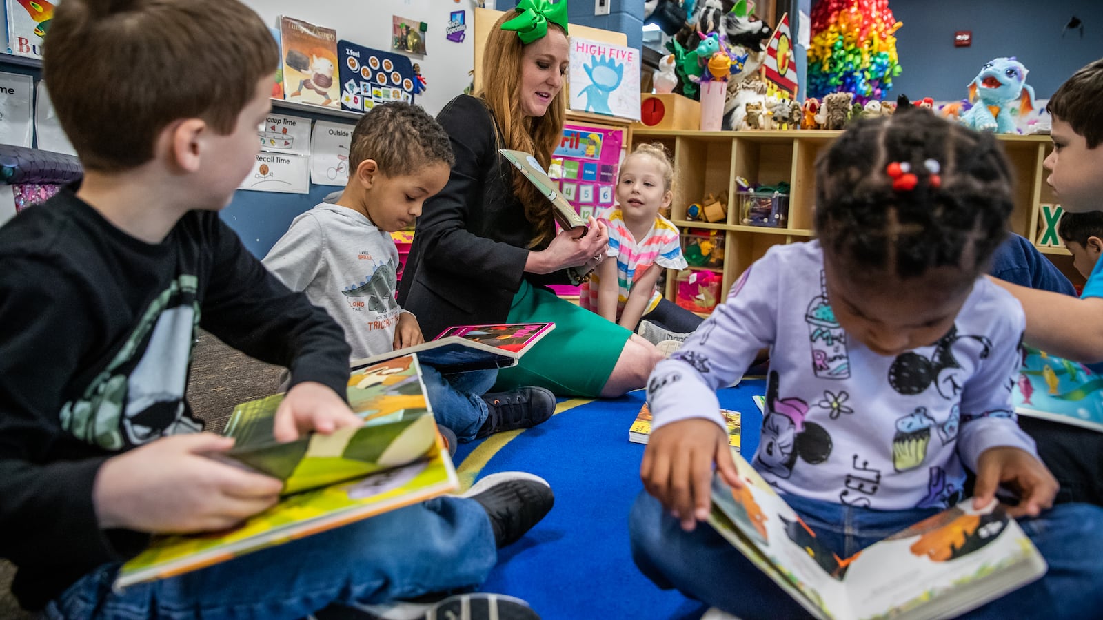 Allison Kempers, a pre-kindergarten teacher at Wayne Township Preschool, reads aloud with her students on Thursday, April 18, 2019.