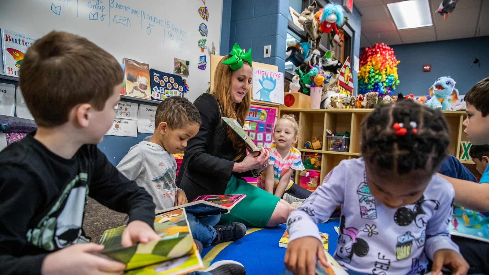 Allison Kempers, a pre-kindergarten teacher at Wayne Township Preschool, reads aloud with her students on Thursday, April 18, 2019.