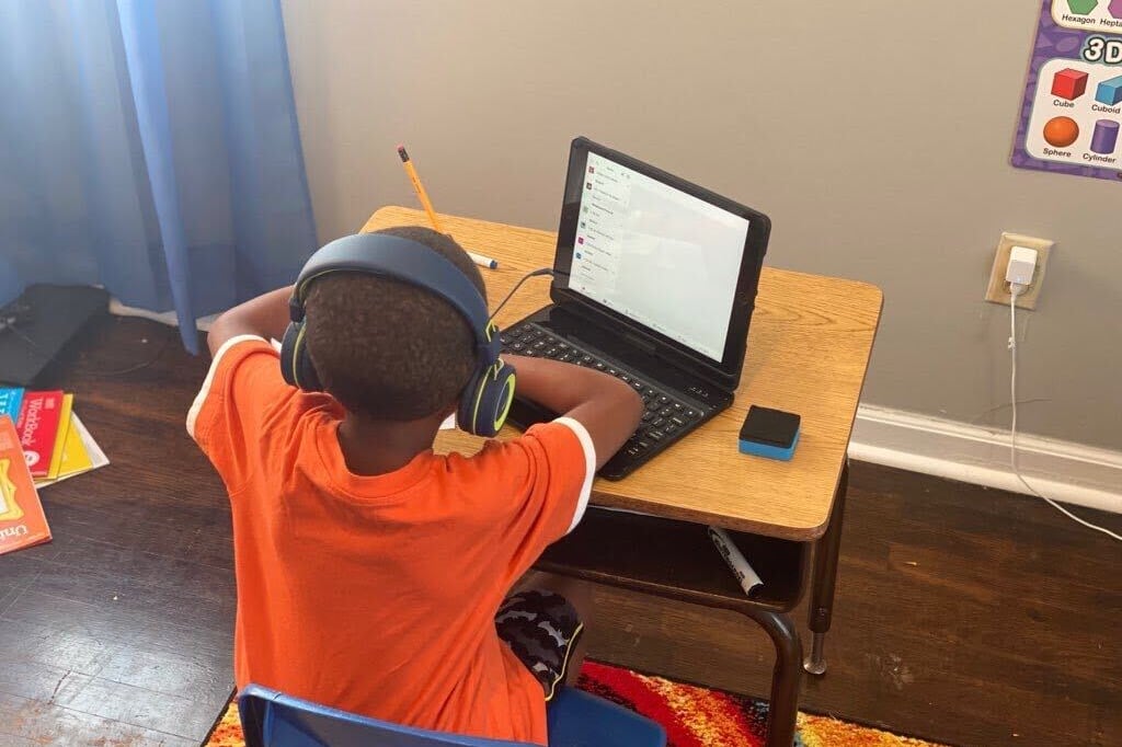 First grader Billy Onley does classwork at his desk at home as part of virtual learning in Shelby County Schools. His mother, Arionna Onley, has started a petition that requests that the virtual school day be shortened from seven hours a day.