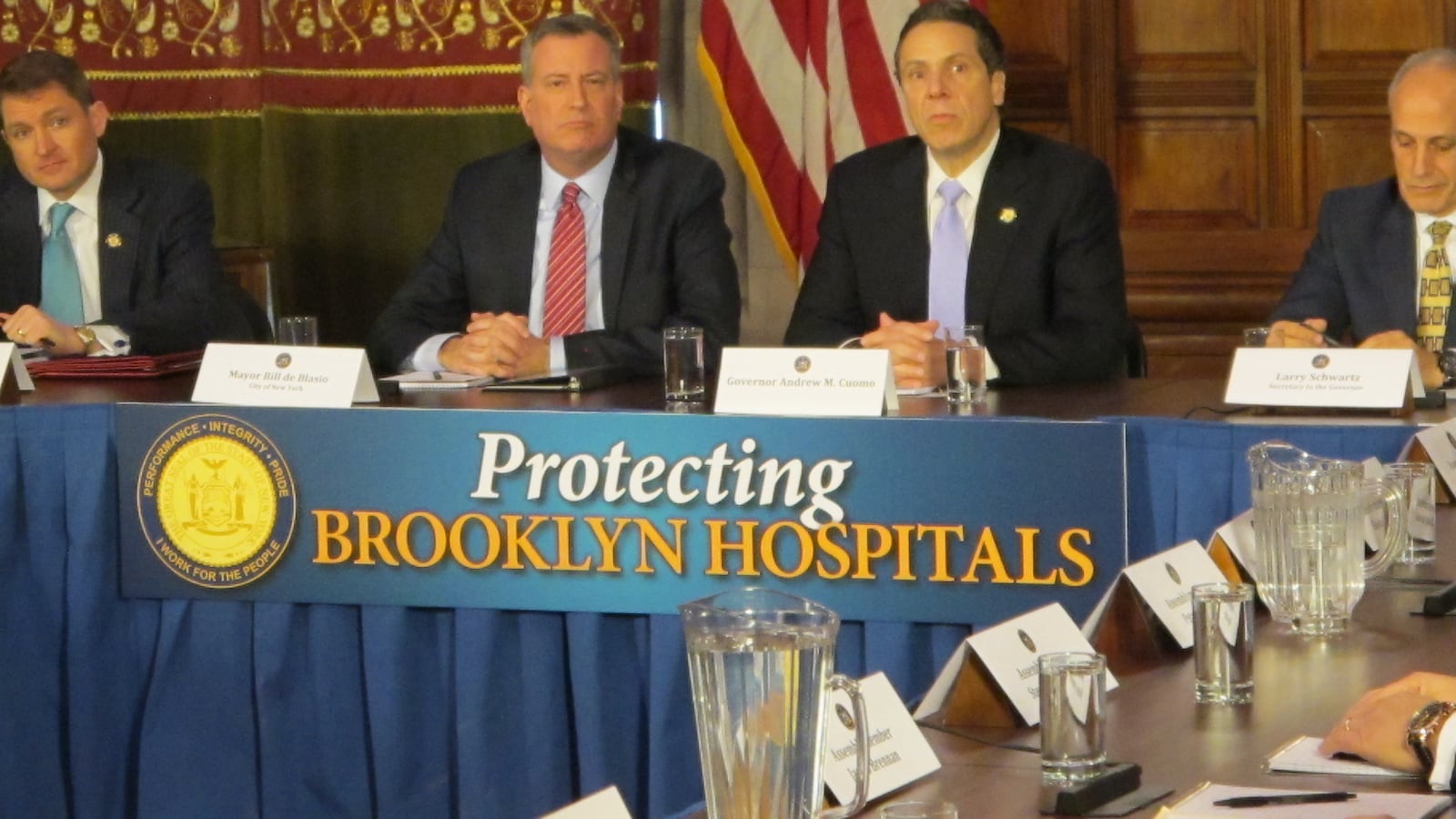 Bill de Blasio and Andrew Cuomo at a press conference in Albany discussing Brooklyn hospitals. The duo played down tension around their competing visions for funding universal pre-kindergarten.